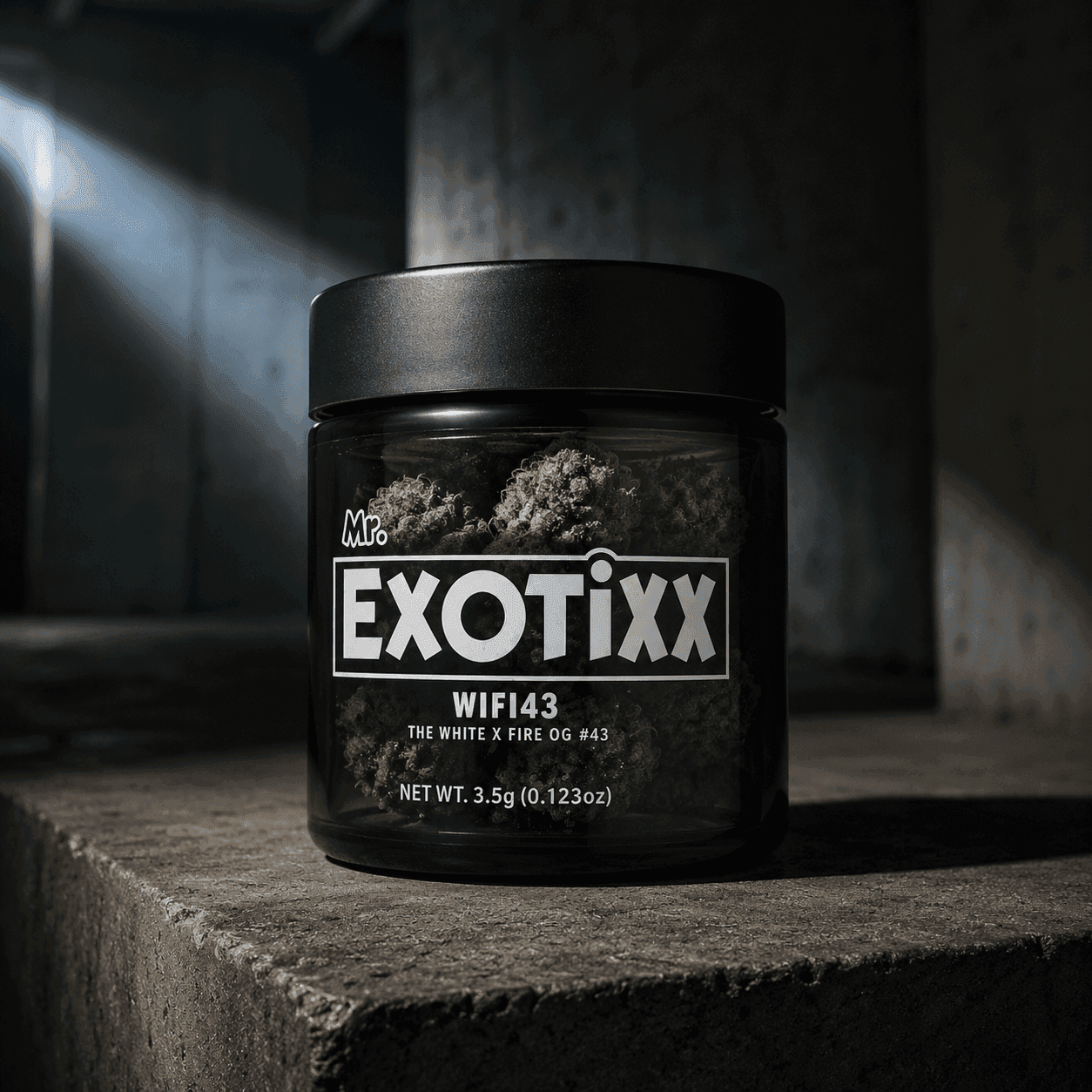 Black jar of Mr. Exotixx WIFI43 cannabis flower on a concrete plinth in a shaft of cold light